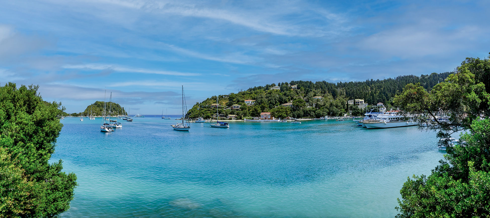 Turquoise Paxos bay with sailboats